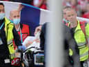 Christian Eriksen is pictured awake on a stretcher as the emergency services remove him from the pitch after administering treatment