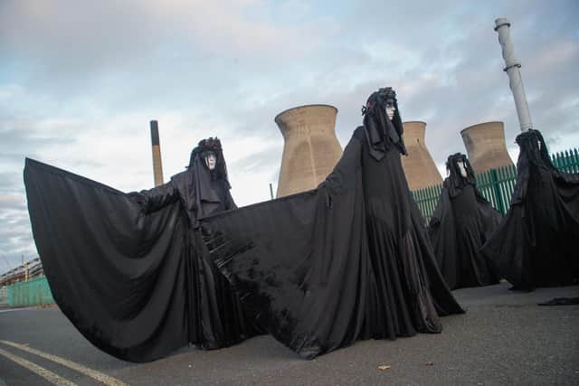 Ocean Rebellion protesters dressed in black theatrical costumes to represent an oil slick at Ineos Grangemouth.