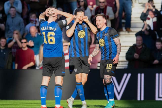 Peter Haring and Andy Halliday react with joking disbelief that Barrie McKay scored his first Hearts goal.