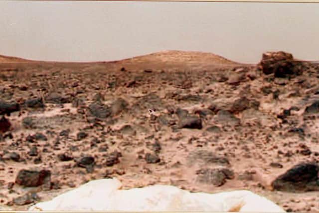 A photograph taken by the Mars Pathfinder Lander shows two large hills in the distance and a portion of the Lander's airbags. Its rover Sojourner was also deployed onto the surface. (Pic: Getty Images)
