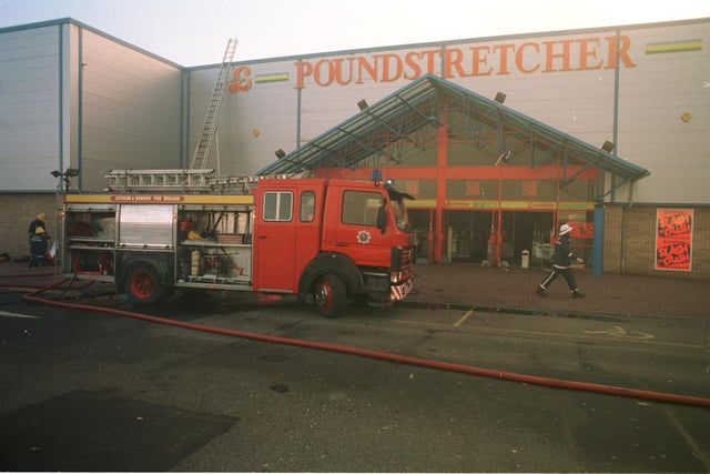 Firefighters try to dampen a fire at the Poundstretcher store at the Fort Kinnaird Retail Park on February 5 1996.