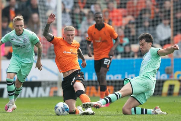 Hibs' Joe Newell challenges Craig Sibbald of Dundee United for the ball