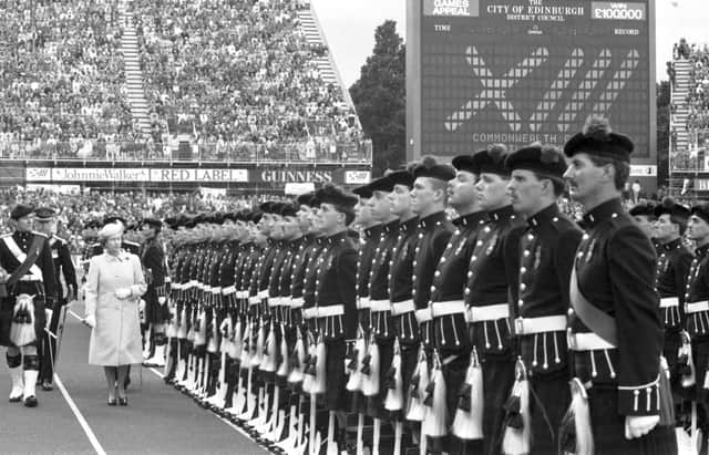 Queen Elizabeth II reviews her guard of honour at the closing ceremony of the Edinburgh Commonwealth Games 1986, held at Meadowbank stadium.