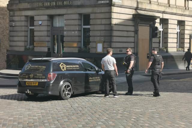Police attend a broken down car on North Bridge in Edinburgh.