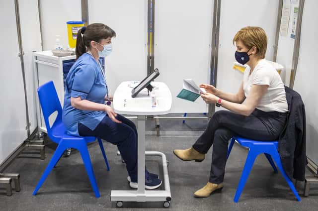 Nicola Sturgeon speaks to staff nurse Elaine Anderson at the NHS Louisa Jordan vaccine centre in Glasgow where the First Minister was inoculated against Covid (Picture: Jane Barlow/PA Wire)