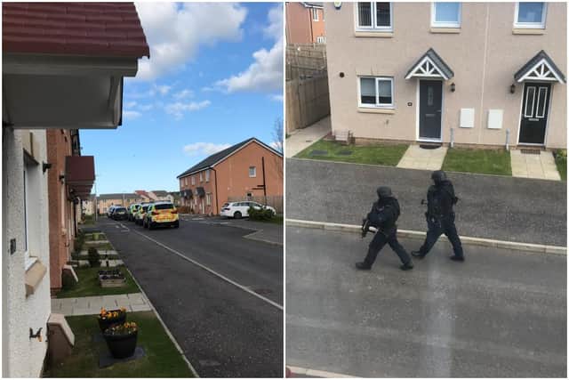 Armed officers pictured walking through Somerset Fields, Musselburgh at about 6pm.