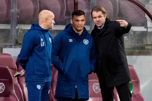 Hearts boss Robbie Neilson discusses tactics with coaches Gordon Forrest and Lee McCulloch during the 6-1 win over Queen of the South.