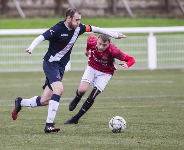 Civil Service Strollers captain Mark McConnell gets ahead of Phil Addison of Gala Fairydean Rovers
