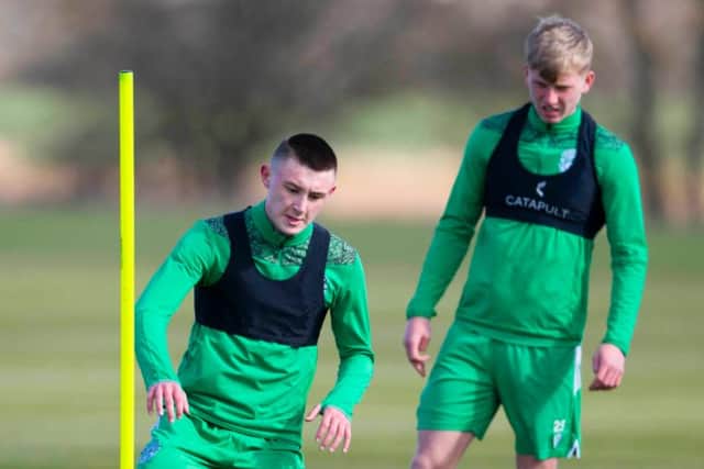 This season's breakout star Josh Doig watches on as 16-year-old Jacob Blaney is put through his paces at the Hibernian Training Centre
