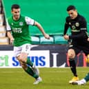Hibs midfielder Stevie Mallan looks to stop Celtic's Mohamed Elyounoussi in his tracks