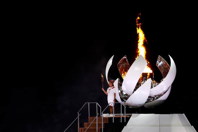 Naomi Osaka, of Team Japan, lights the Olympic flame during the opening ceremony of the Tokyo Games, at which Team GB athletes came fourth in the medal table (Picture: Maddie Meyer/Getty Images)