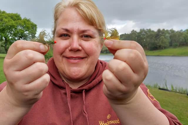 Iona Allan with two of her popular flies. Picture by Nigel Duncan