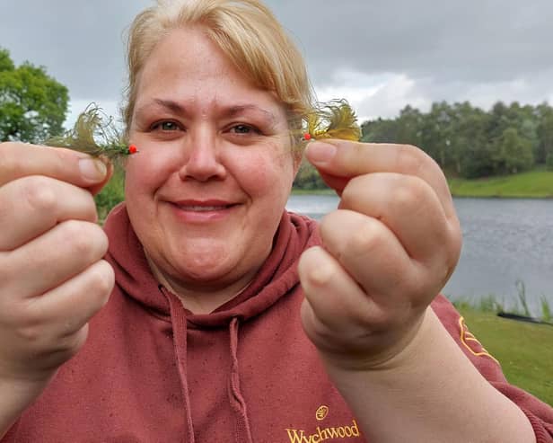 Iona Allan with two of her popular flies. Picture by Nigel Duncan