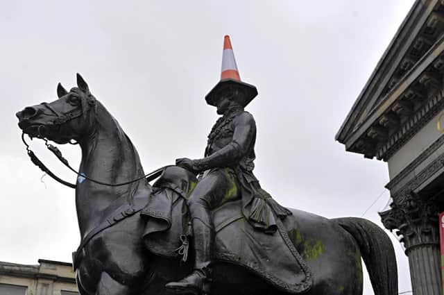 Glasgow is known for many things, including the traffic cone on the Duke of Wellington's statue. This year it could become synonymous with the fight against climate change (Picture: Andy Buchanan/AFP via Getty Images)