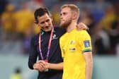 Nathaniel Atkinson is controlled by an Australian coach after his team's 4-1 loss to France at Al Janoub Stadium. Picture: Robert Cianflone/Getty