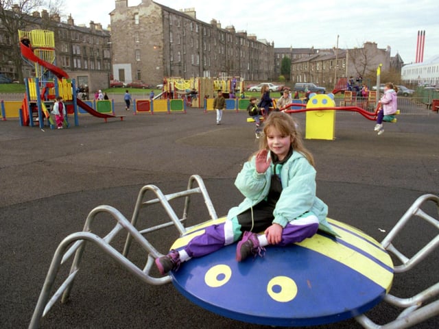 A ittle girl waves to the photographer from one of the climbing frames at the newly-refurbished playground in Edinburgh's Montgomery Street in December 1990.
