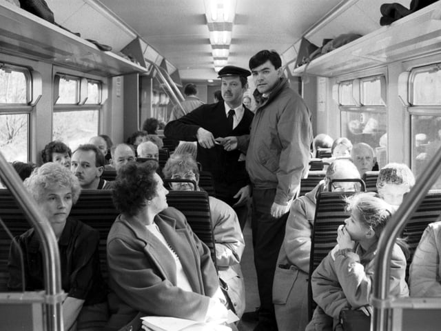 The Abbeyhill Action Group take a train ride in March 1989 after proposing that the Abbeyhill loop should be re-opened in March 1989. Group organiser Harold Nicholson is pictured checking Councillor David Begg's ticket.