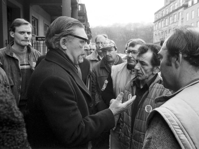 Scottish NUM leader Mick McGahey speaks to miners as he leaves a meeting to discuss prolonging the miners strike in Scotland in March 1985.