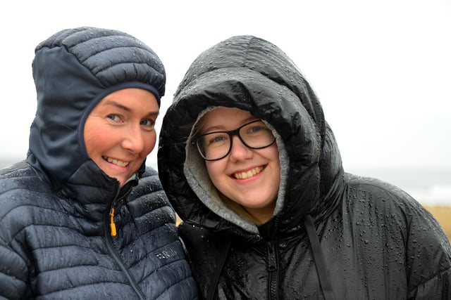 Caroline Harrison, left, and Emma Thomlinson brave the rain.