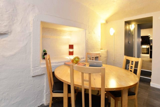 The dining area is situated off the lounge, in this charming basement flat near the city centre.