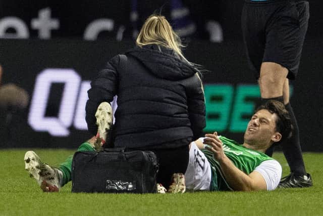 Midfielder Joe Newell receives treatment for an injury during the Edinburgh derby last month