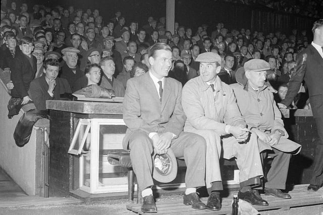 Willie Bauld watches his Hearts v Sheffield testimonial game from the trainers' bench at Tynecastle in 1962.