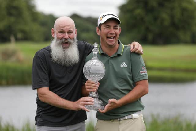 Lucas Herbert shows off the trophy with his caddie Nick Pugh after winning the Dubai Duty Free Irish Open at Mount Juliet. Picture: Patrick Bolger/Getty Images.