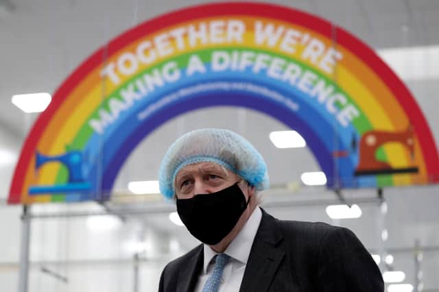 Boris Johnson wears a face mask during a visit to a PPE manufacturing facility (Picture: Scott Heppell/WPA pool/Getty Images)