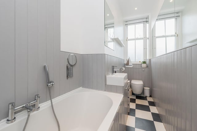 The family bathroom has a three-piece white suite, including a bath with a shower head.