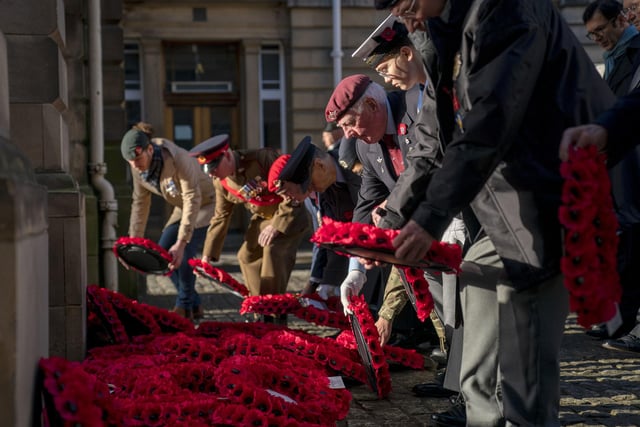 More Poppy wreaths are laid at the Stone of Remembrance during a Remembrance Sunday service and parade in Edinburgh. 
Photo: Jane Barlow/PA Wire