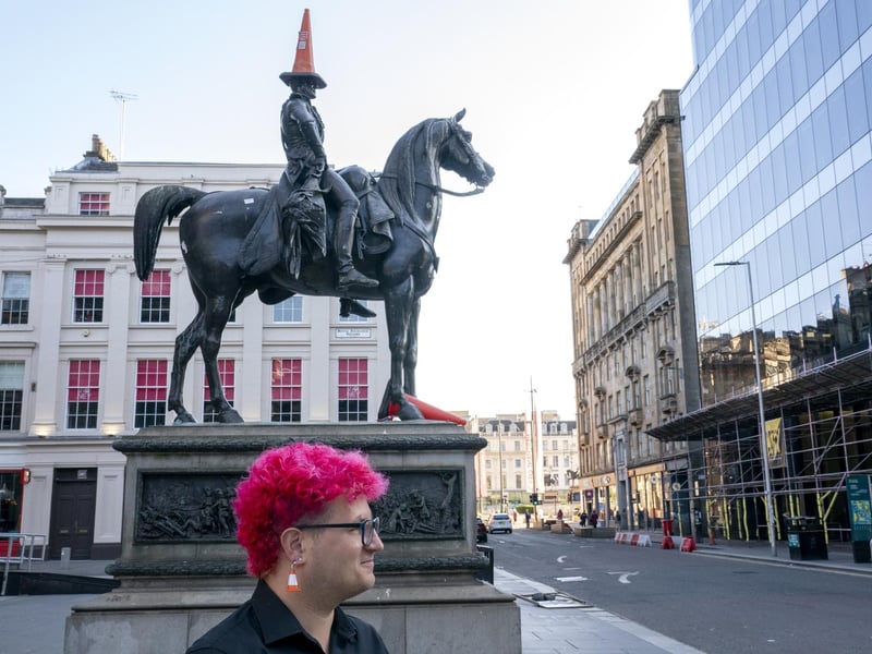 Gallery steward Louisa Mcgeachie, stands by the Duke of Wellington statue, which now wears a traffic cone, consider by many to be the first original piece of 'street art' outside Glasgow's GoMA where the new show by street artist Banksy 'Cut & Run' opens this Sunday, revealing for the first time the stencils used to create many of the artist's most iconic works.