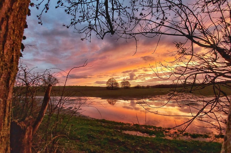 Craig Middleton captured a fiery, orange sunset with treetop reflections in the lake.