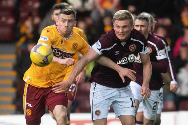 Motherwell's Connor Shields fights with Taylor Moore for possession during Hearts' 2-0 loss. Picture: SNS