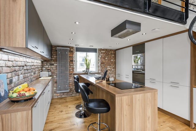 The stylish kitchen is the heart of the home with all integrated appliances and a sociable island with space for dining.