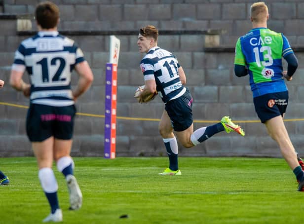 Jack Blain scores the second try for Heriot's during a FOSROC Super6 match against Boroughmuir Bears at Meggetland