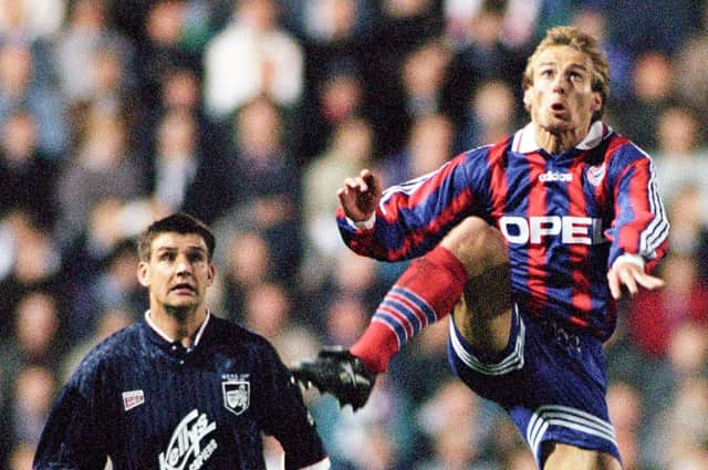 Bayern Munich's Jurgen Klinsmann (right) wins the ball ahead of Raith's Shaun Dennis in the UEFA Cup 2nd round first leg tie at Easter Road on October 17, 1995.