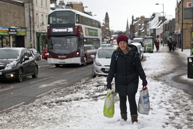 One woman smiled as she plodded through the heavy snow in Musselburgh with her shopping bags.