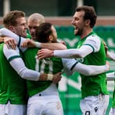 Hibs players swarm matchwinner Martin Boyle as they moved five points ahead of their main rivals, Aberdeen, in the chase for third place. Photo by Ross Parker / SNS Group