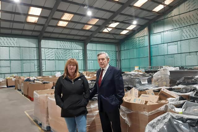 Pauline Buchan and Gordon Brown at the Cottage Centre warehouse filled with goods destined for families in need across Fife