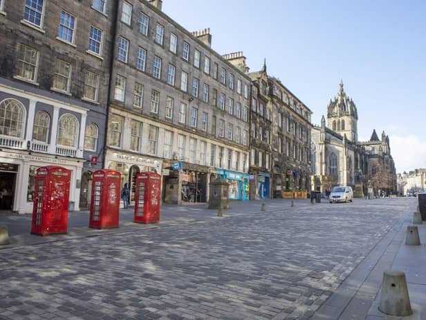 Edinburgh's normally busy Royal Mile is largely deserted after government advice urged the public not to visit pubs or restaurants