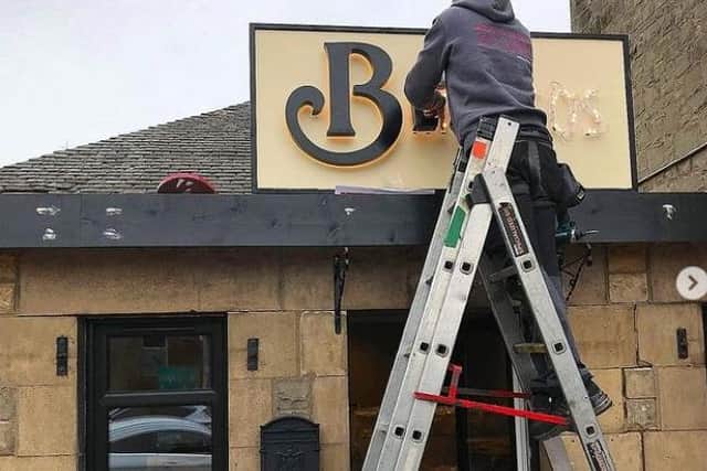 The new sign for Bennitos was put up on Tuesday.