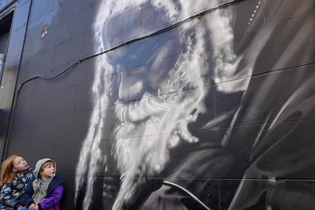 Bonnie Thompson, age 6 and Euan Thompson, age 5 visit the mural of Arthur Williams on Arthur Street, Leith