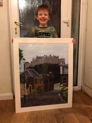 Murray Gray, 8, with the donated painting.
