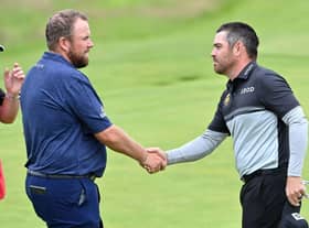 Defending champion Shane Lowry shakes hands with Louis Oosthuizen after their opening round in the 149th Open at Royal St George's. Picture: Paul Ellis/AFP via Getty Images.