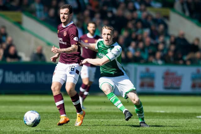 Jake Doyle-Hayes putting Hearts midfielder Andy Halliday under pressure during a 1-0 victory for Hibs at Easter Road last season. Picture: SNS