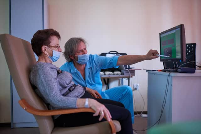A therapist explains test results to a long Covid patient (Picture: Bartosz Siedlik/AFP via Getty Images)