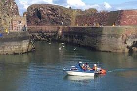 The lifeboat tows the stricken vessel into Dunbar harbour. Picture: Ian Wilson/Dunbar RNLI
