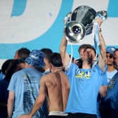 Manchester City's John Stones celebrates on stage with the Champions League Trophy during the Treble Parade in Manchester earlier this month (Picture: Nigel French/PA)