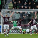 Toby Sibbick finishes off a chance from close range but his celebrations would be cut short as the goal was ruled out for offside before VAR intervened to award Hearts a penalty against Hibs. Picture: SNS