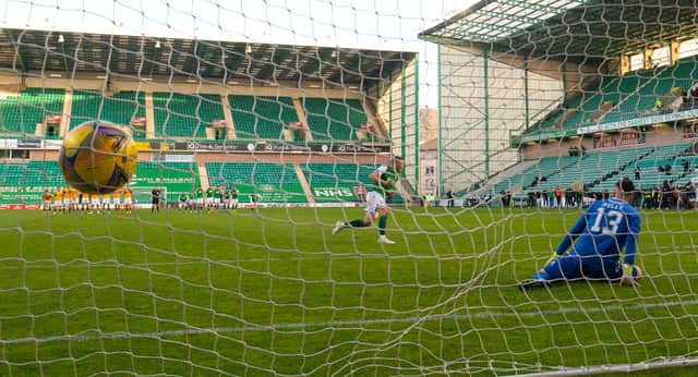 Hibs' Ryan Porteous scores the winner from the penalty spot against Motherwell.
